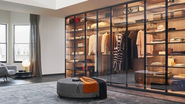 Poliform walk-in wardrobe with sliding doors and soft matte finishes — minimalist Italian furniture.